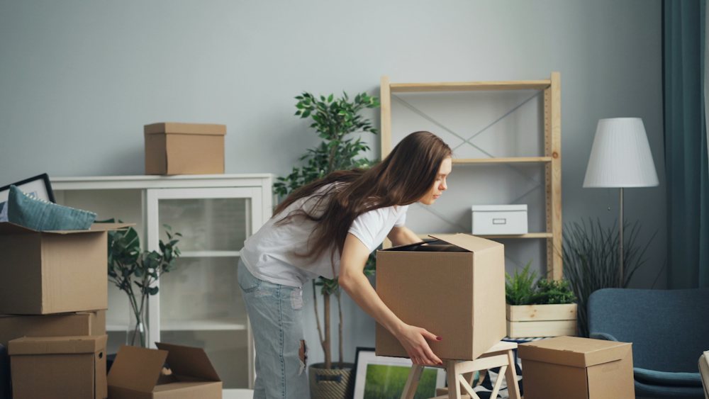 Woman unpacking boxes in her new apartment